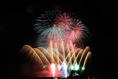 Low angle view of firework display at night