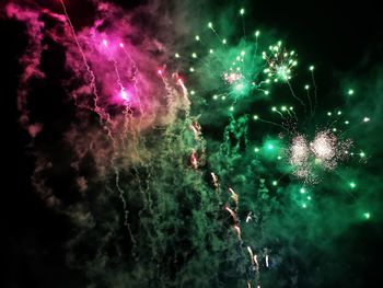 Low angle view of firework display at night