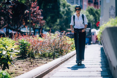 Man wearing sunglasses standing by plants