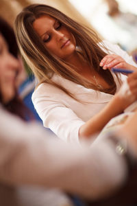 Businesswoman sitting on table at office