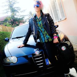 Young woman standing by car