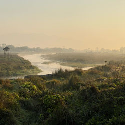 Scenic view of landscape against sky during foggy weather