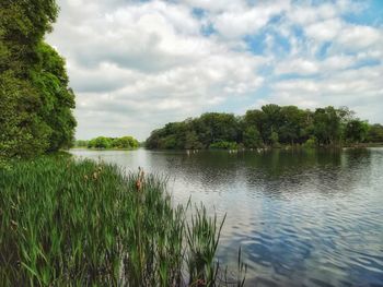 Scenic view of lake against cloudy sky