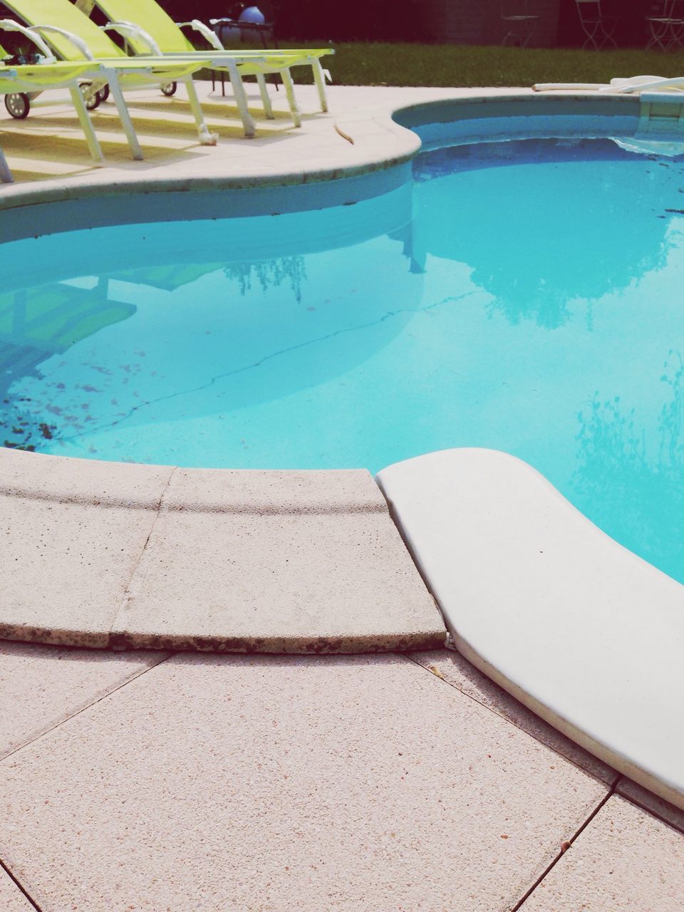 water, swimming pool, blue, high angle view, reflection, turquoise colored, built structure, transparent, day, architecture, sunlight, glass - material, outdoors, no people, sea, swimming, tiled floor, tile, nature