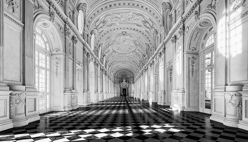 Low angle view of cross on tiled floor against building