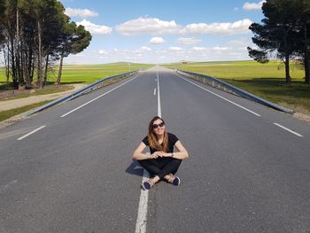 Portrait of woman sitting on road