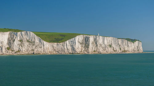 Scenic view of sea against clear blue sky