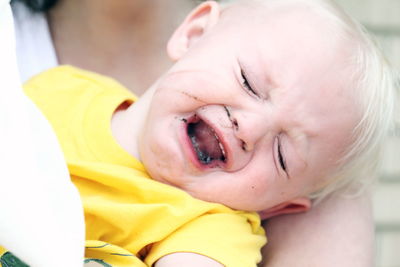 Close-up portrait of cute boy with eyes closed