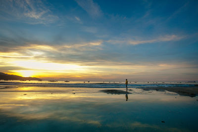 Scenic view of beach against sky during sunset