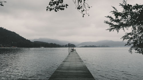 Pier over lake against sky