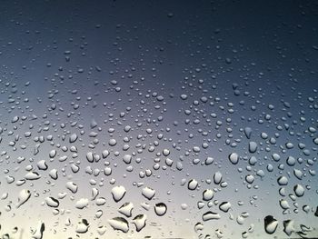 Full frame shot of raindrops on windshield