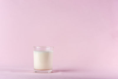 Close-up of drink against pink background