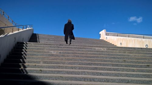 Low angle view of people walking on stairs