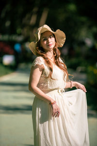 Portrait of woman wearing hat standing outdoors