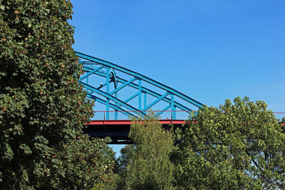 Low angle view of bridge against clear blue sky