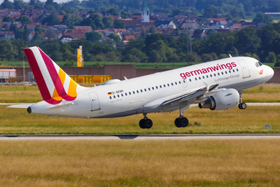 Airplane flying over airport runway