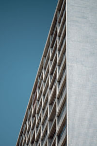 Low angle view of modern building against clear blue sky