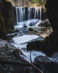 Scenic view of waterfall in forest long exposure 