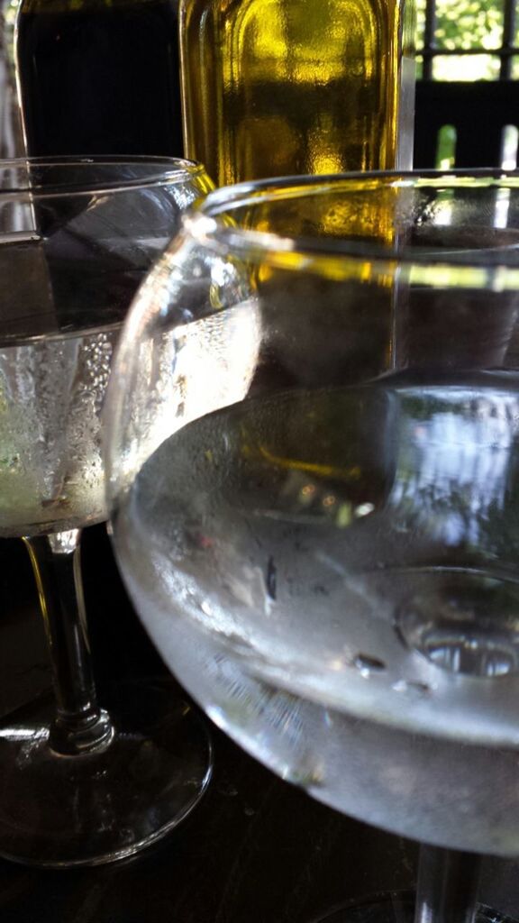 CLOSE-UP OF WINE GLASSES ON TABLE