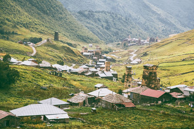 High angle view of houses on field by mountain old village in the mountains, history, towers launch