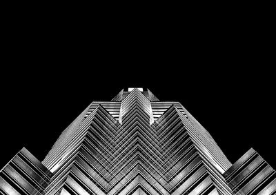 Low angle view of modern building against sky at night