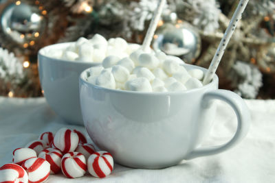 Close-up of marshmallows in cup on table