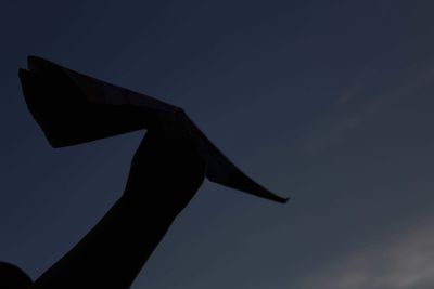 Low angle view of silhouette statue against sky