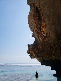 Rock formation on sea against sky