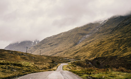 Road amidst mountains against sky