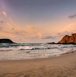 Scenic view of beach against sky during sunset