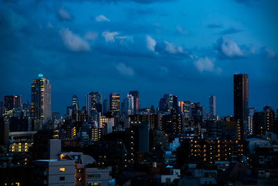 Illuminated cityscape against sky