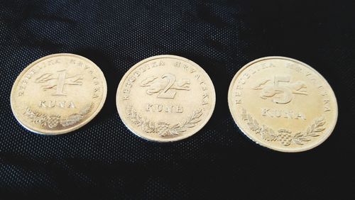 High angle view of coins on black background