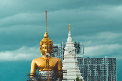 Statue of buddha against building