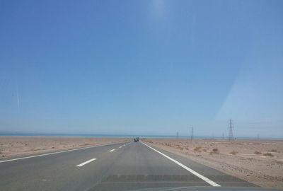 Empty road along trees