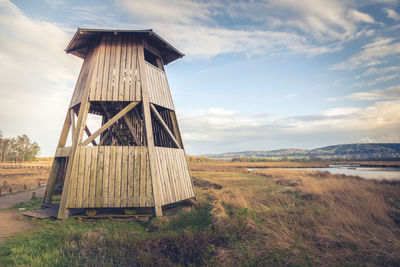 Built structure on field against sky