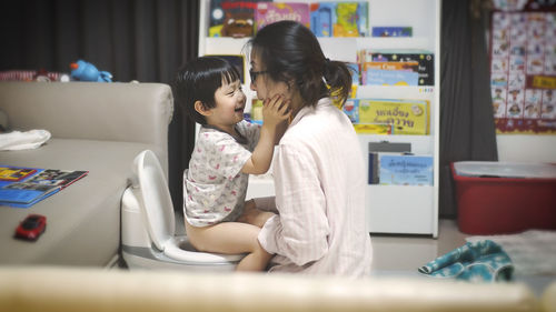 Women sitting on table at home