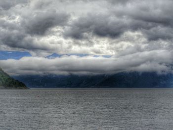 Scenic view of landscape against cloudy sky