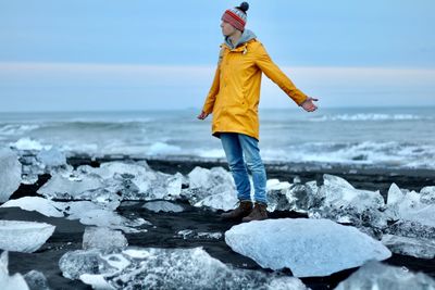 Full length of man standing at beach during winter