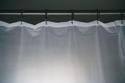 Close-up of clothes drying against white wall