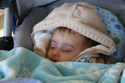 Close-up of cute baby sleeping in bed