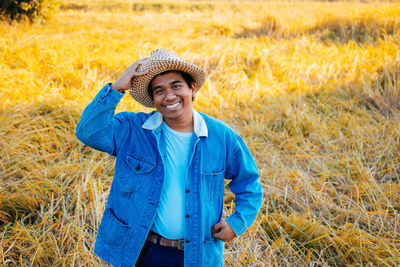 Portrait of a smiling young man in field