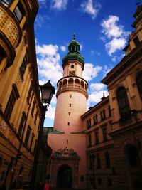 Low angle view of bell tower against sky