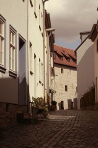 Street amidst buildings in town against sky