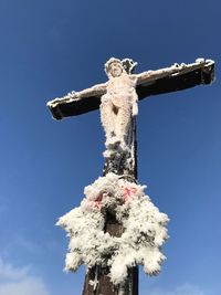 Low angle view of statue against blue sky