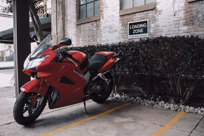 Motorcycle parked on street against buildings in city