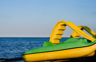 Close-up of yellow floating on sea against clear sky