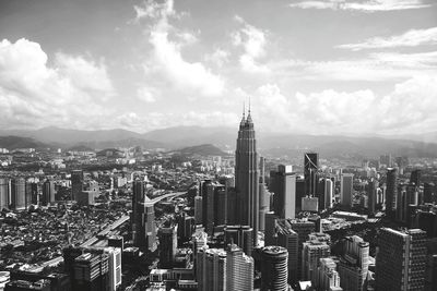 Cityscape against cloudy sky