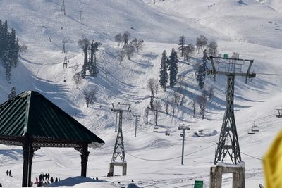 Ski lift over snow covered mountains