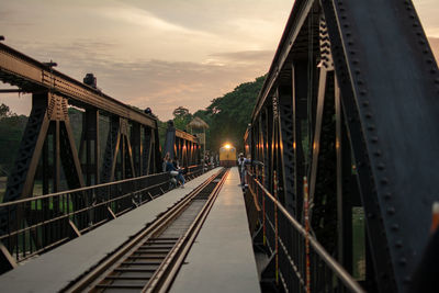 Railway bridge against sky at sunset