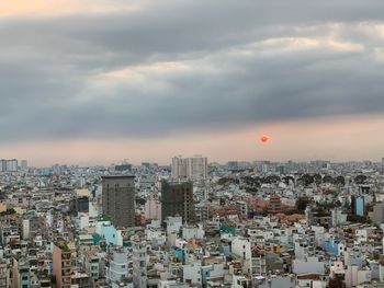 High angle view of city buildings against sky during sunset